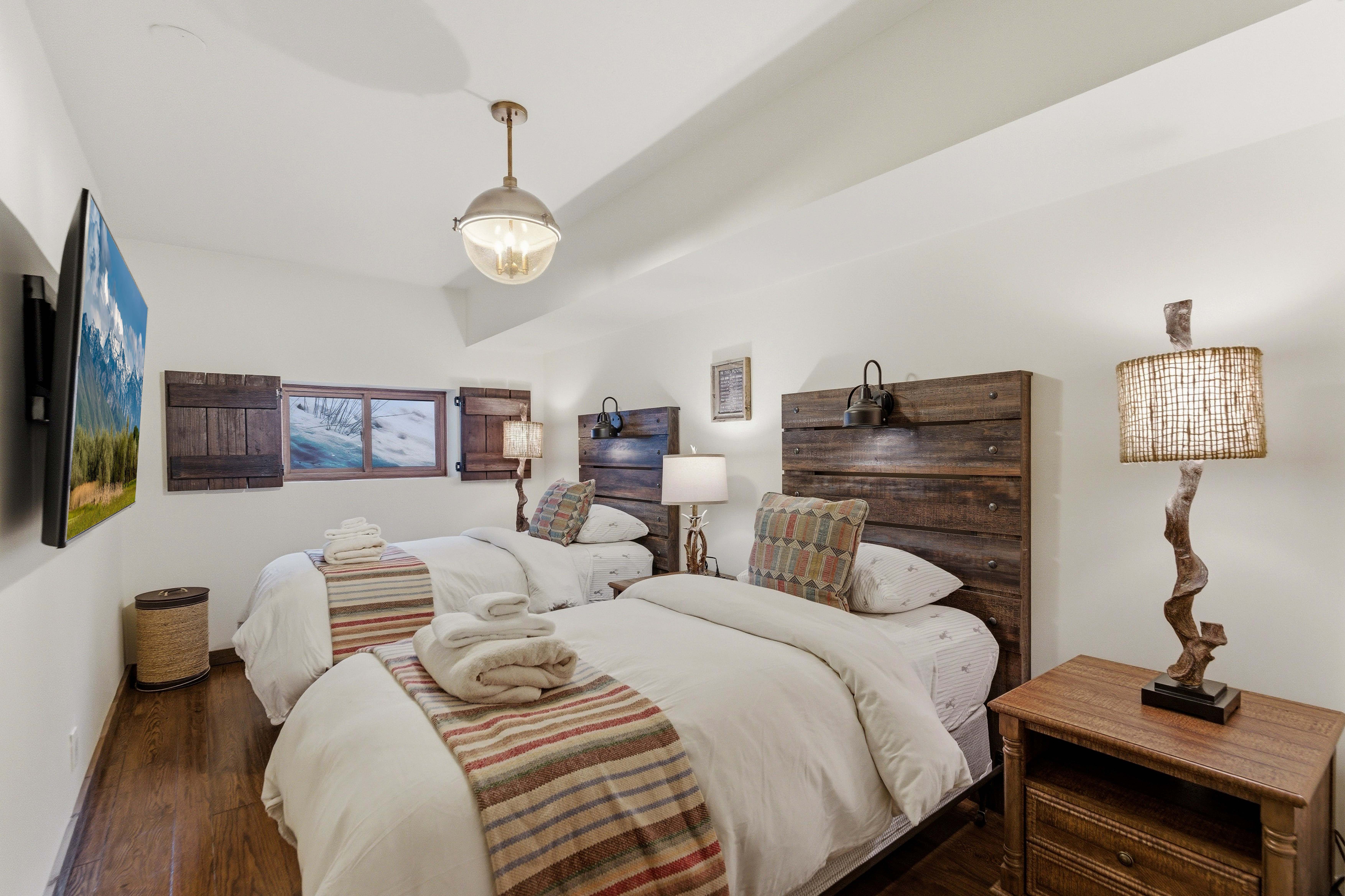 Bedroom with wood finished floors and baseboards