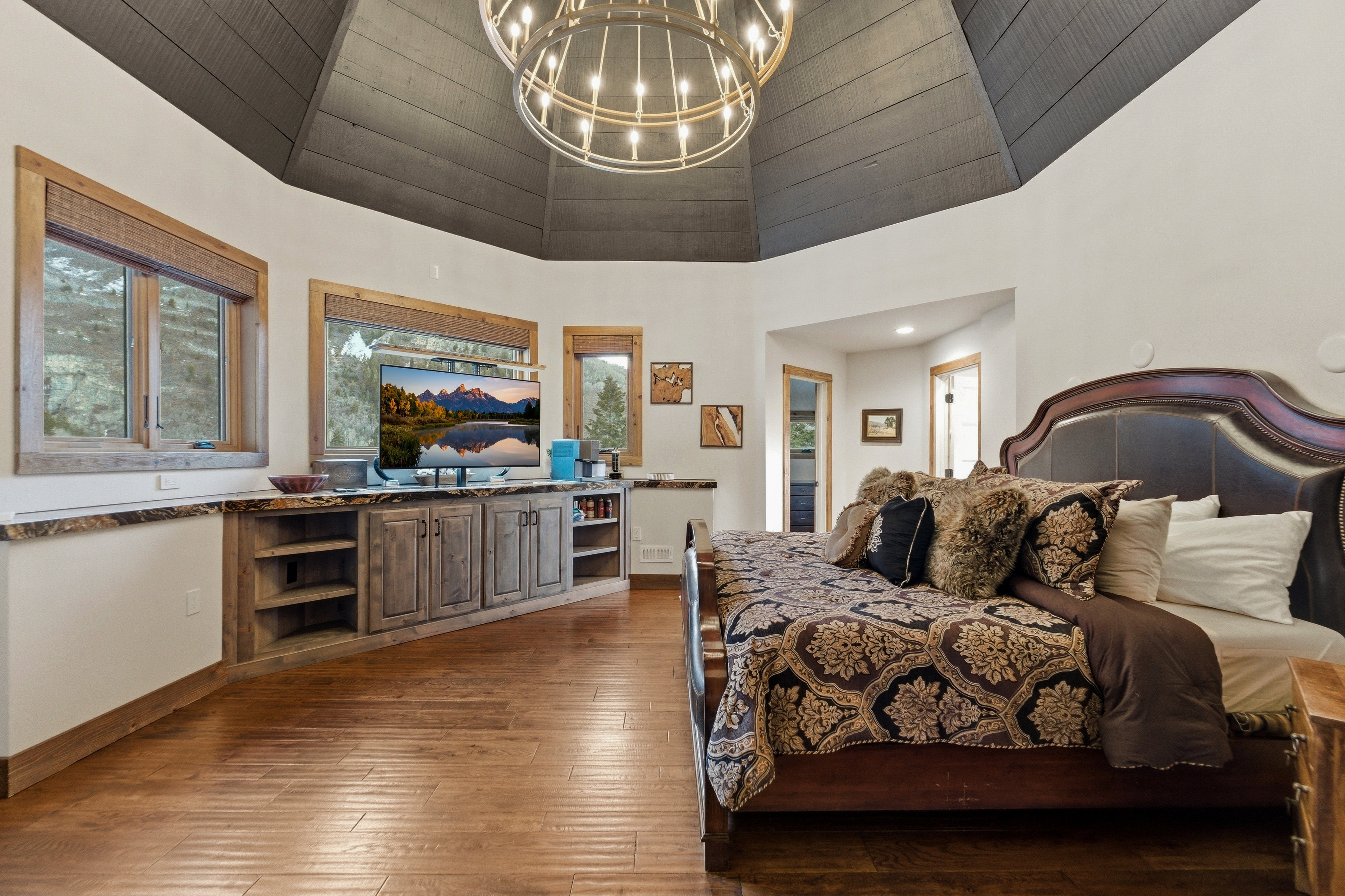 Bedroom featuring a chandelier and dark wood-type flooring