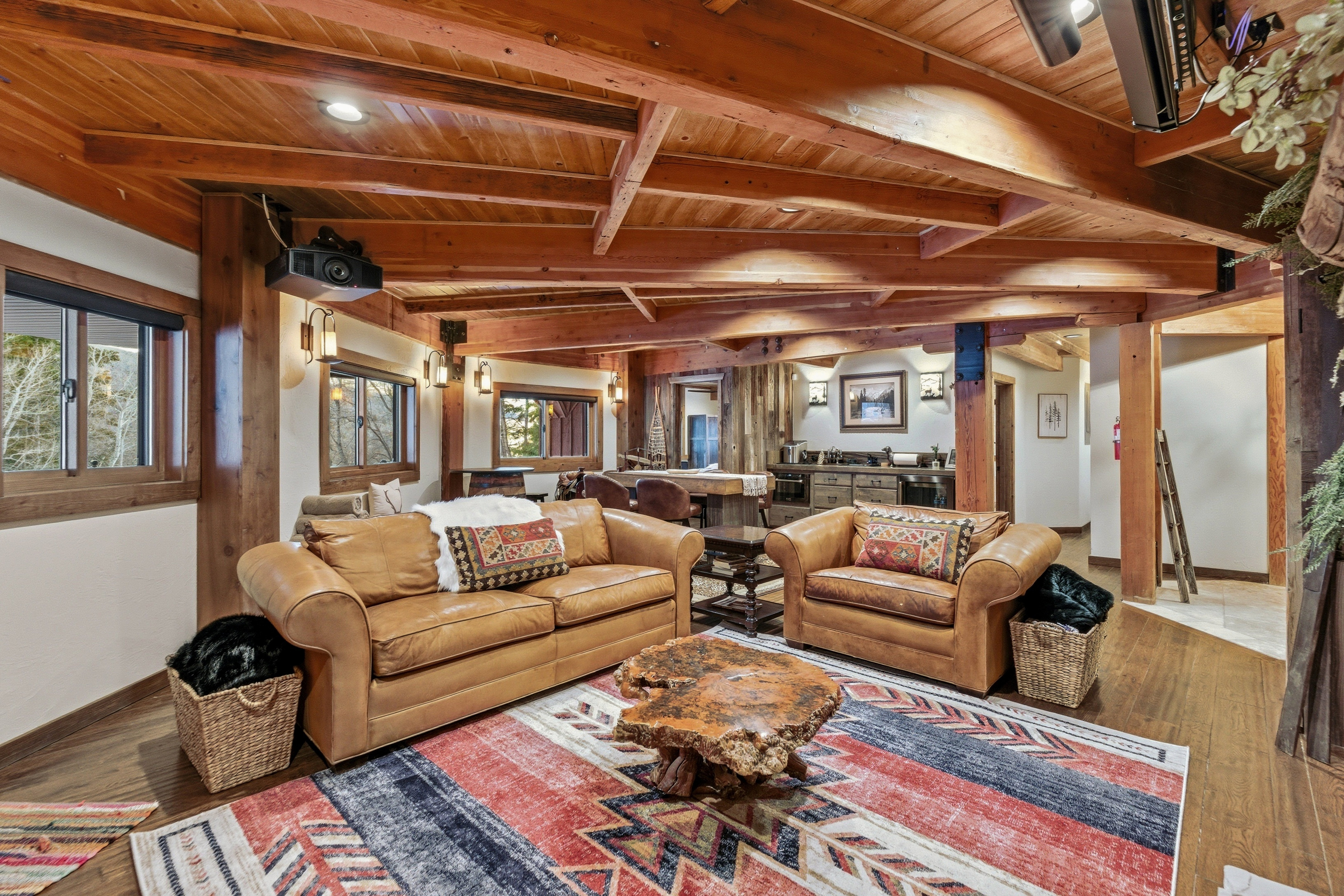 Living room with a wooden ceiling with exposed beams and wood finished floors