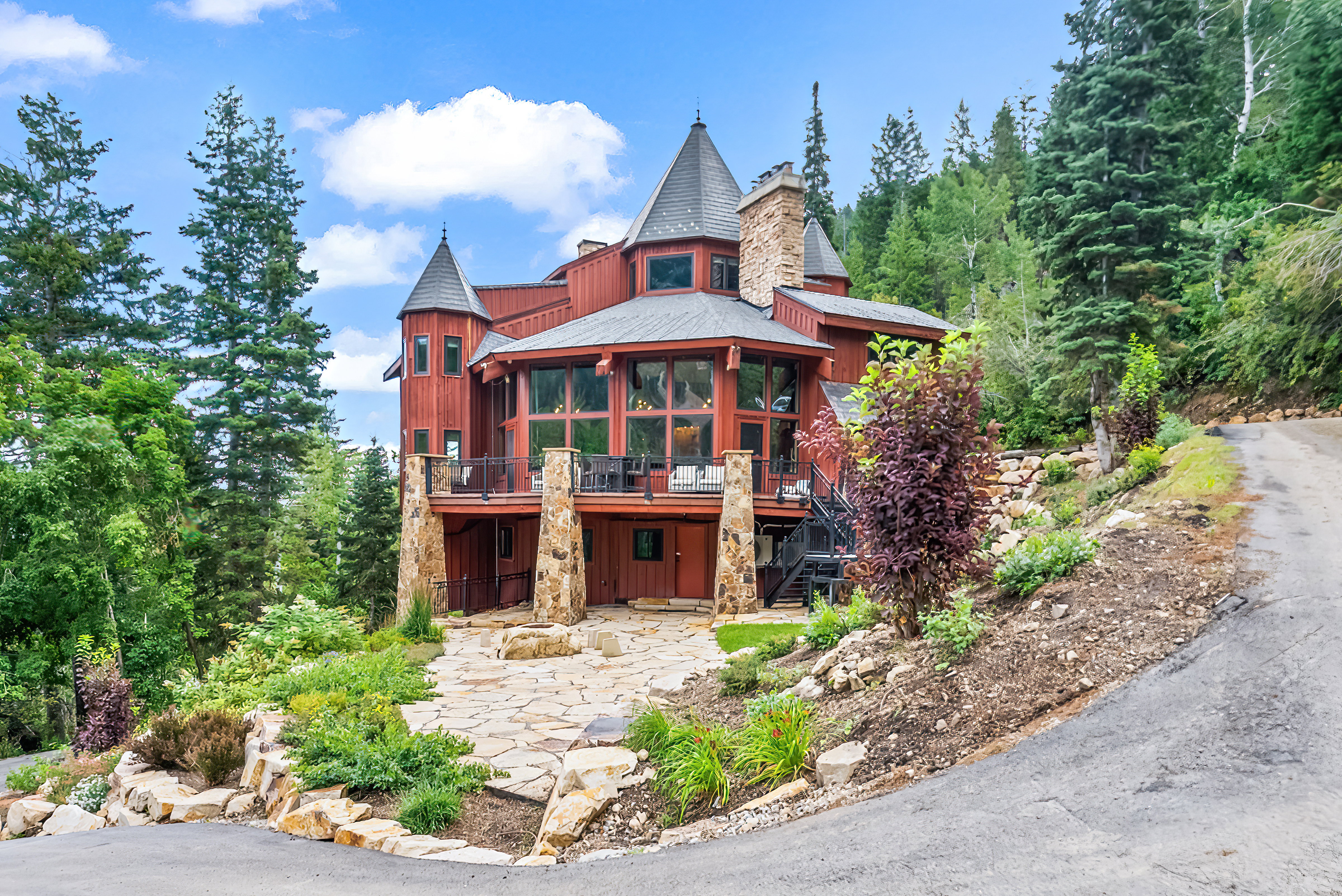 View of front of property featuring a deck, a chimney, and a patio
