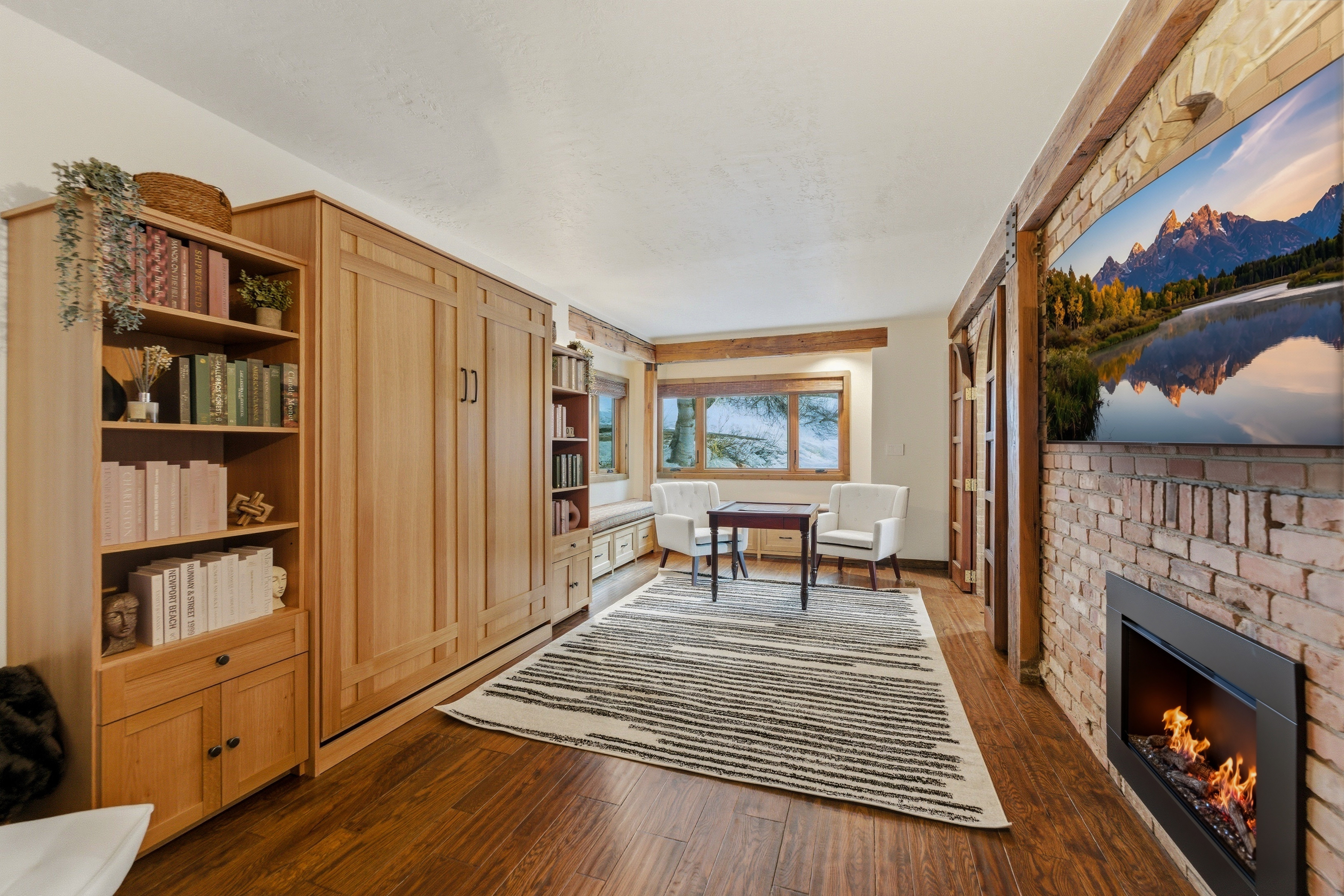Office space with a brick fireplace and dark wood-type flooring