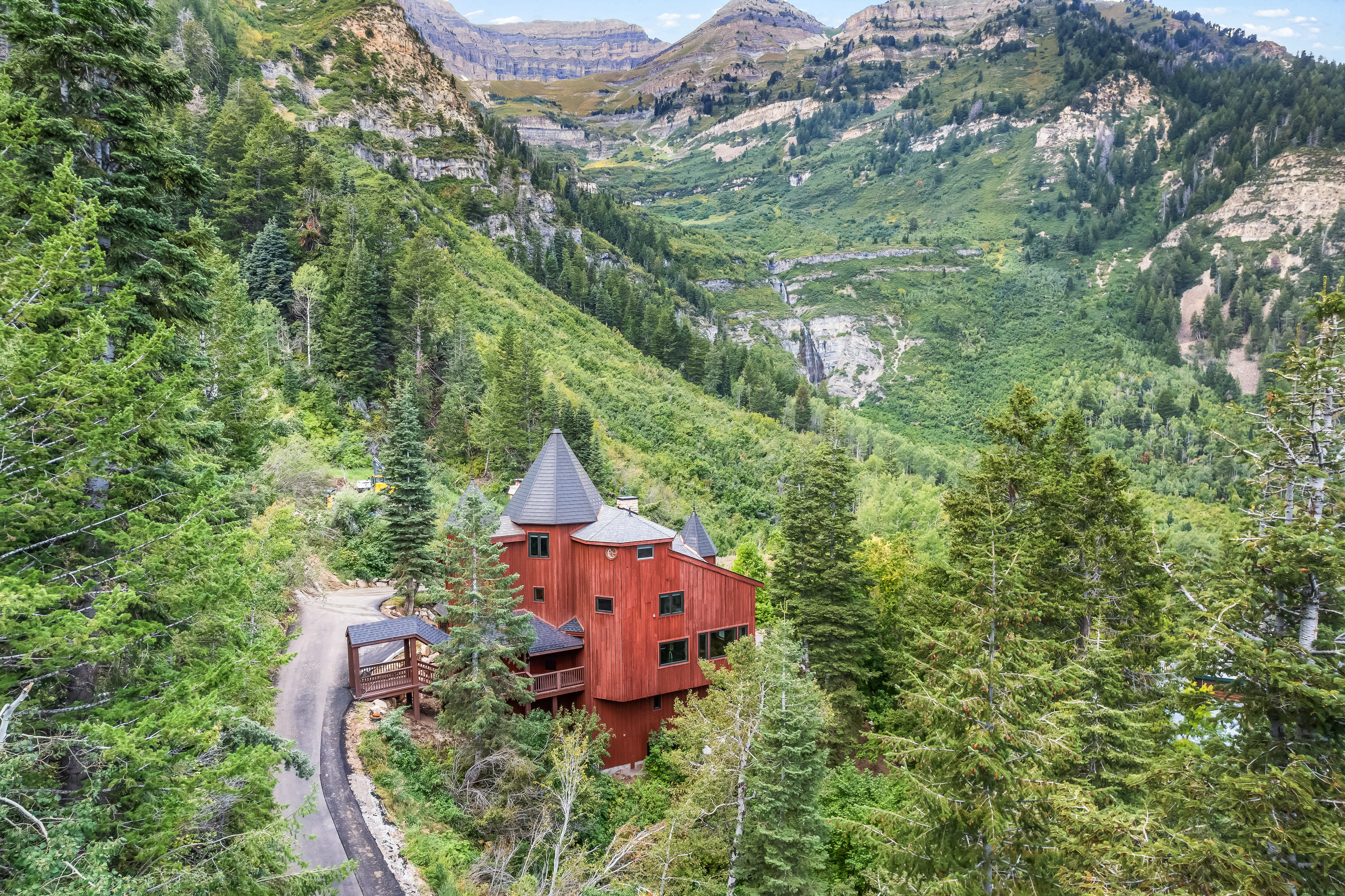 View of subject property with mountains and a forest