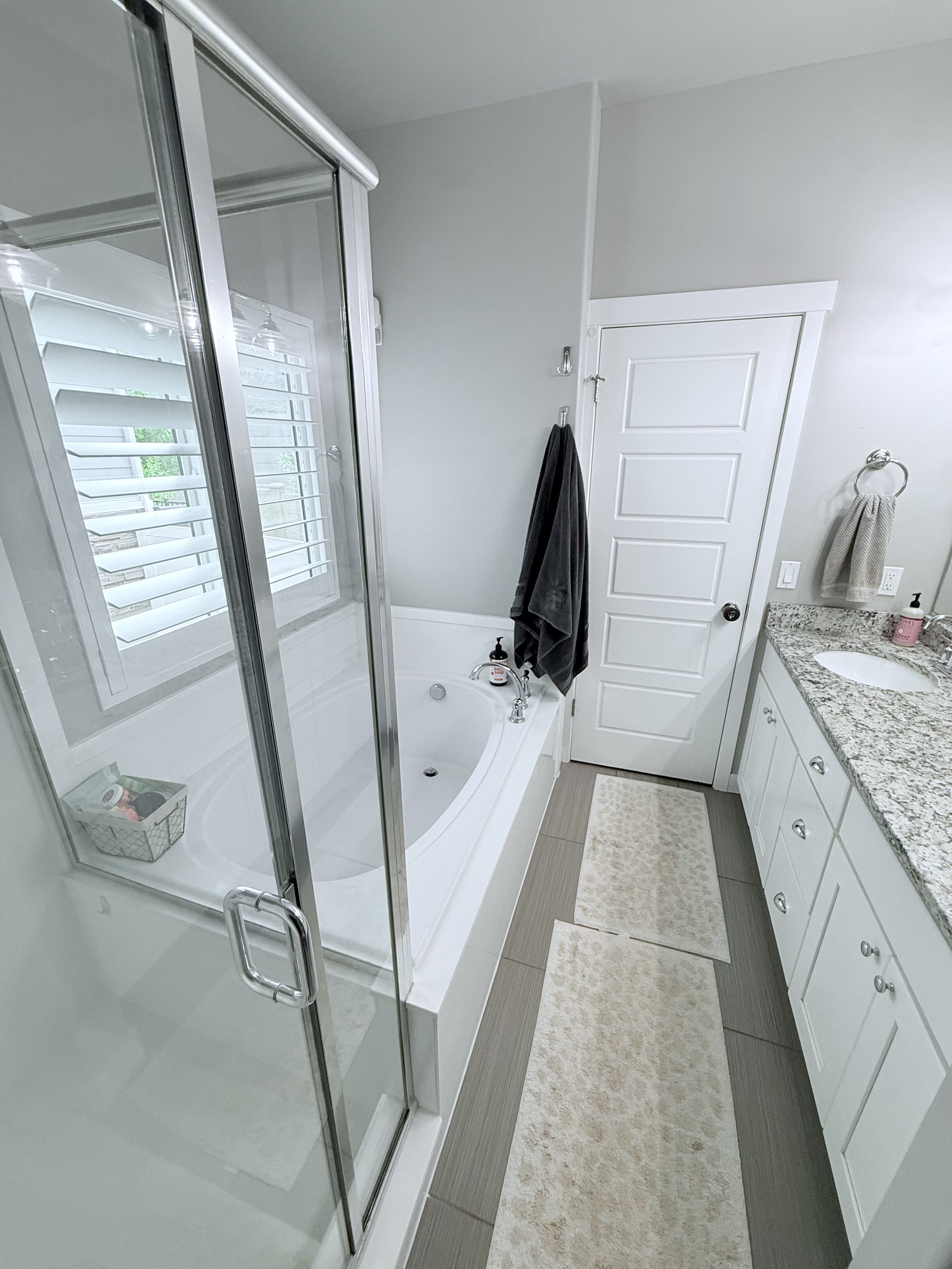 Bathroom featuring vanity, a shower stall, and a bath
