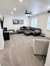Living room with carpet, recessed lighting, and ceiling fan