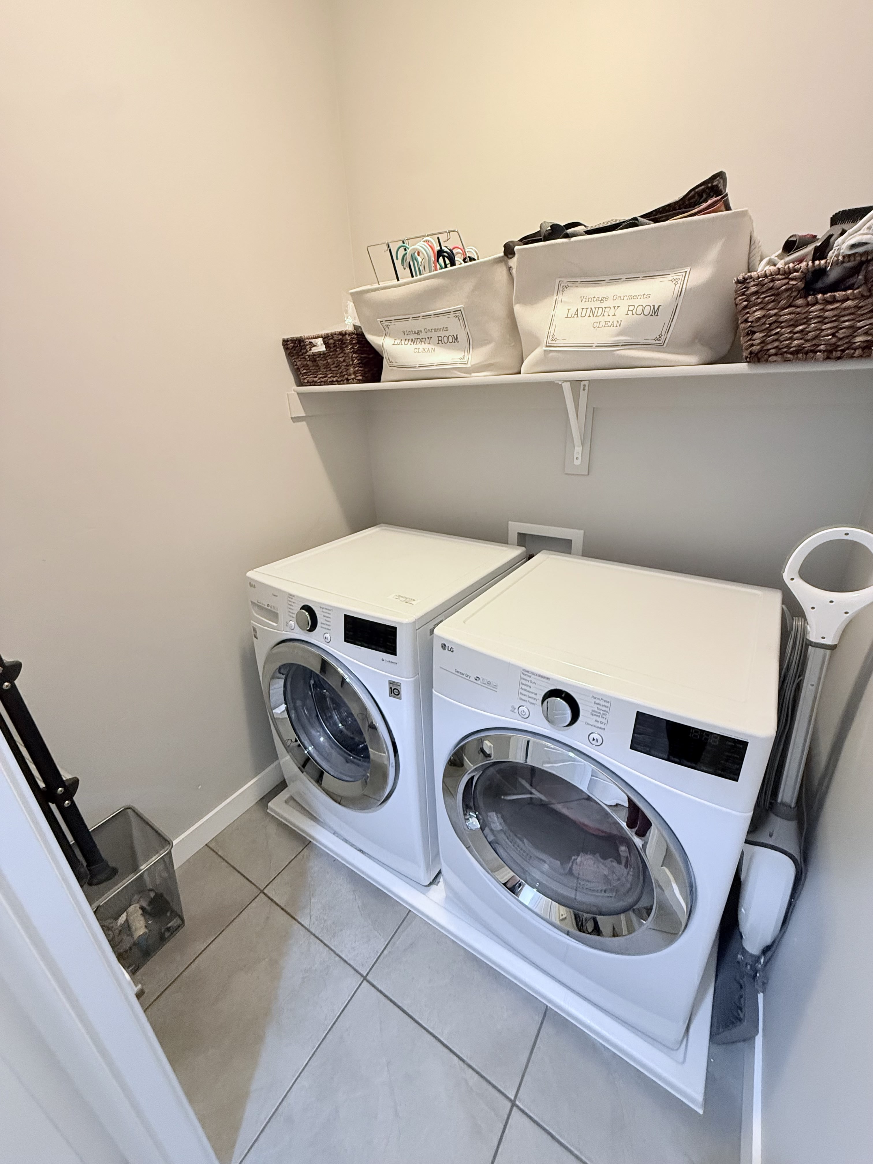 Laundry area featuring light tile patterned floors and separate washer and dryer