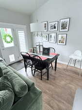 Dining room with vaulted ceiling and wood finished floors