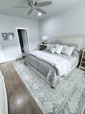 Bedroom featuring wood-type flooring and ceiling fan