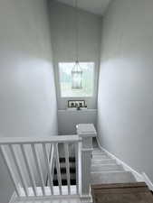 Stairway with baseboards and carpet flooring