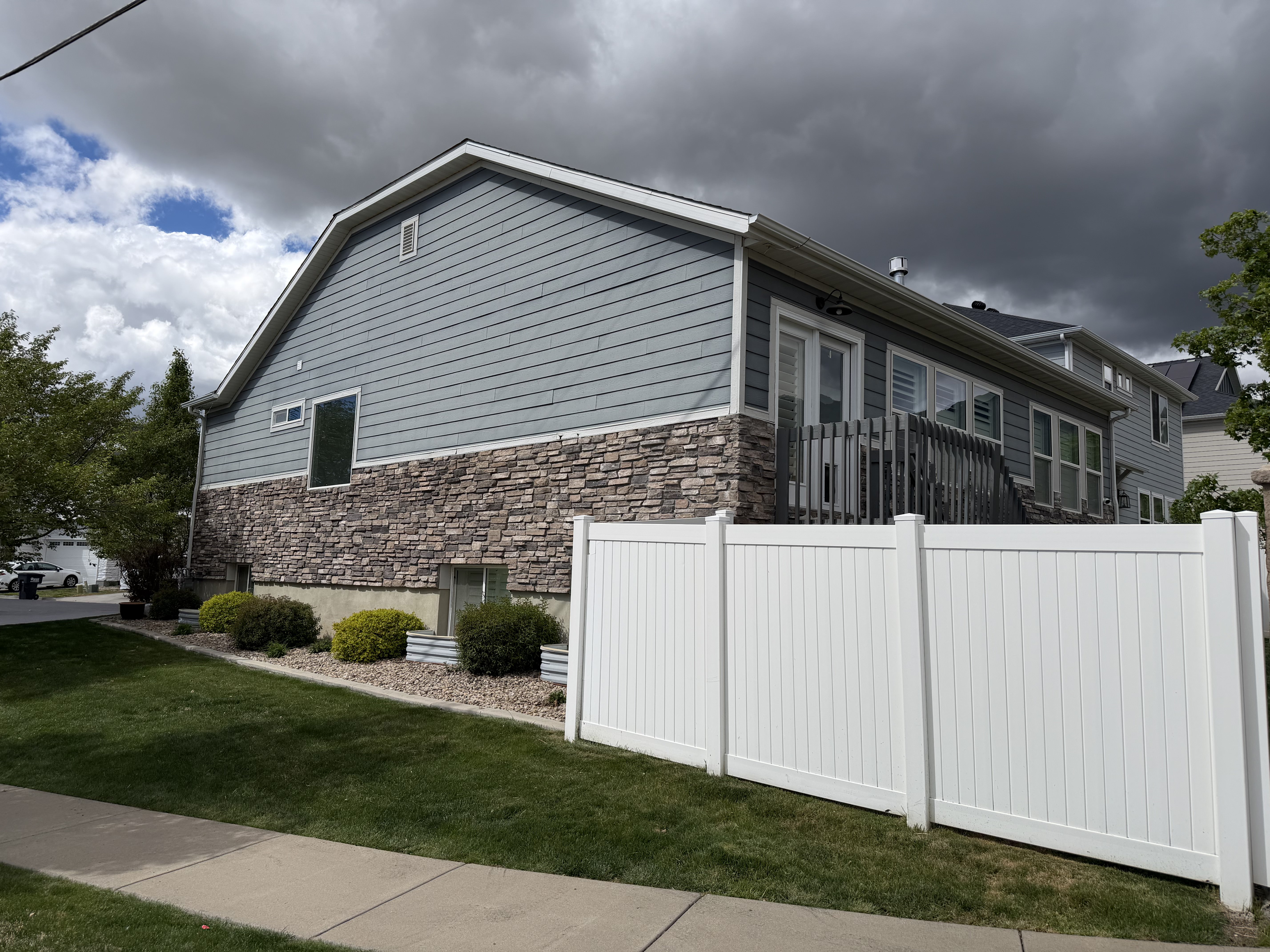 View of side of property featuring stone siding