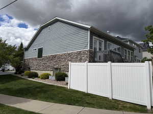 View of side of property featuring stone siding
