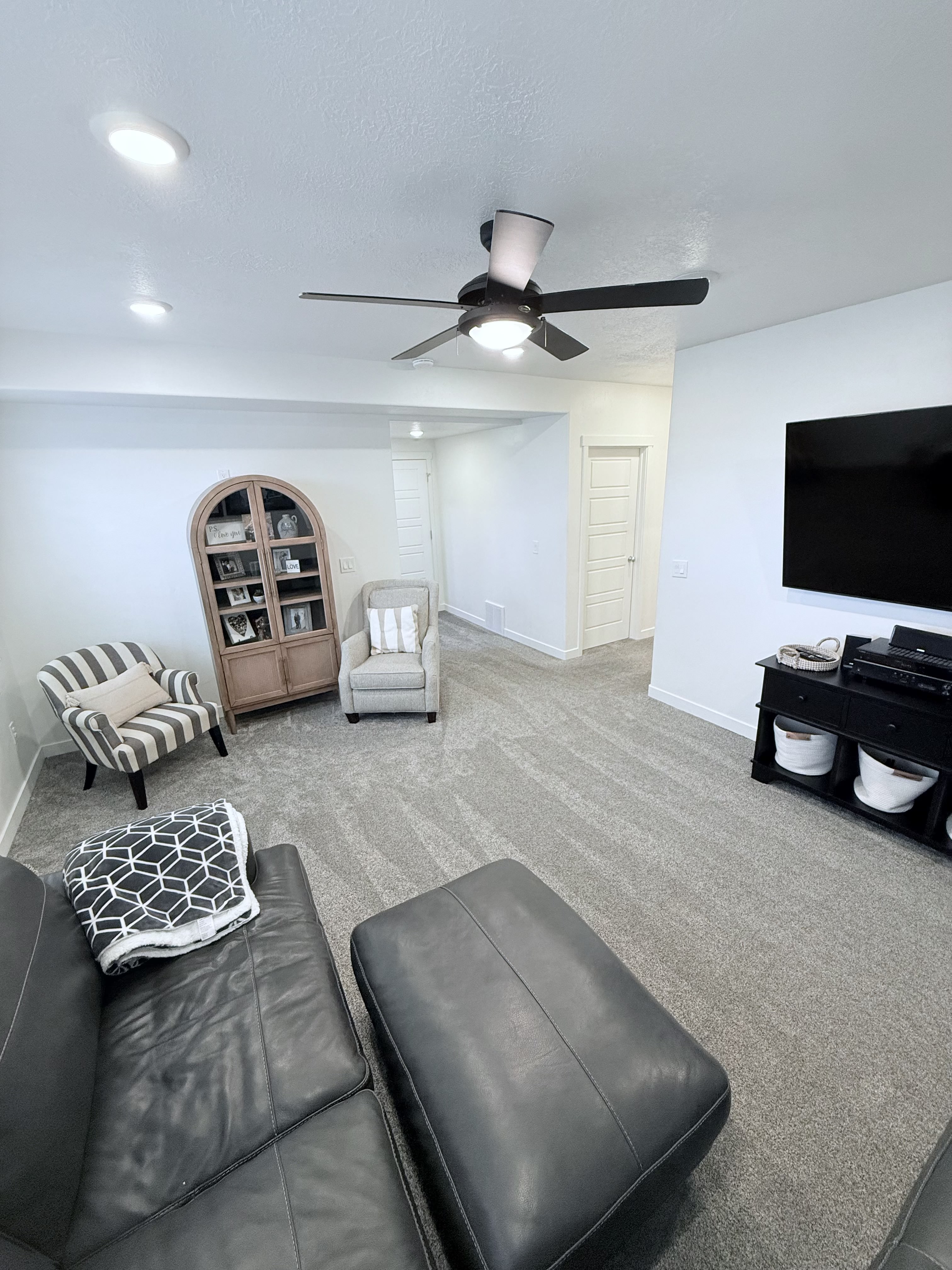Living room featuring carpet floors, a ceiling fan, and recessed lighting