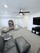 Living room featuring carpet floors, a ceiling fan, and recessed lighting