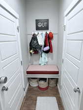 Mudroom with dark wood-style flooring and baseboards