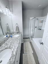 Bathroom with double vanity, a stall shower, and a bath