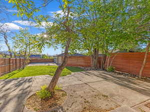Fenced backyard featuring an outdoor structure