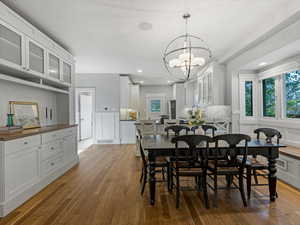 Dining area featuring wood flooring and a built in hutch
