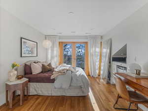 Bedroom featuring french doors to balcony and a wet bar