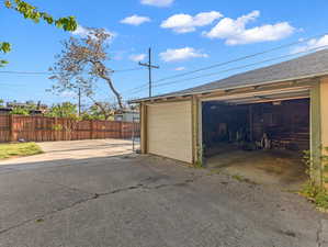 View of detached garage and extra parking