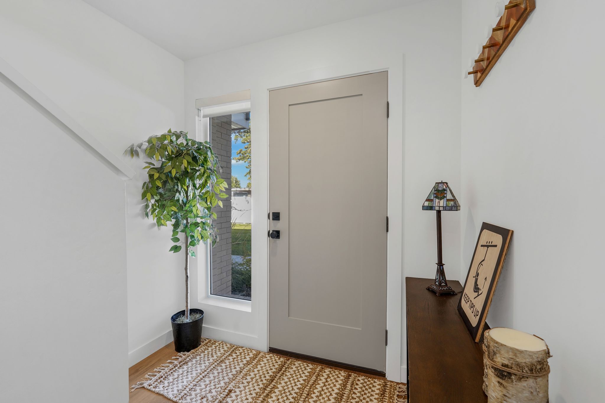 Entryway with baseboards and light wood-style floors