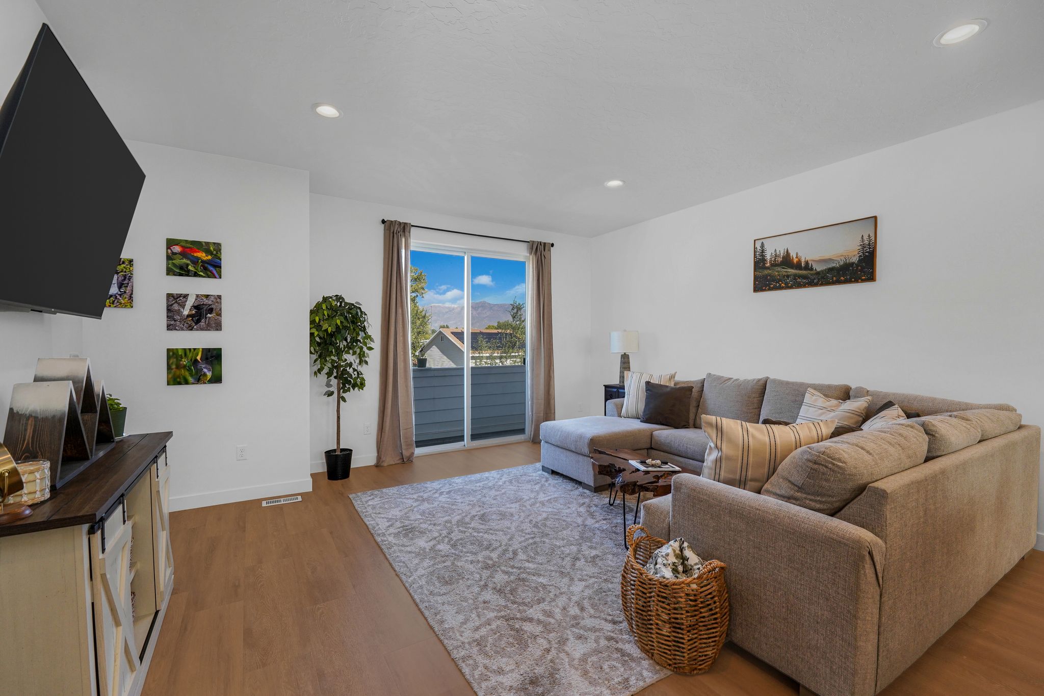 Living area featuring light wood finished floors and recessed lighting