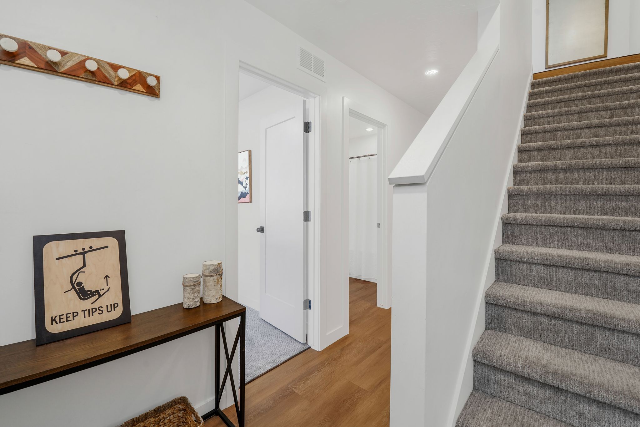 Stairs featuring wood finished floors and recessed lighting