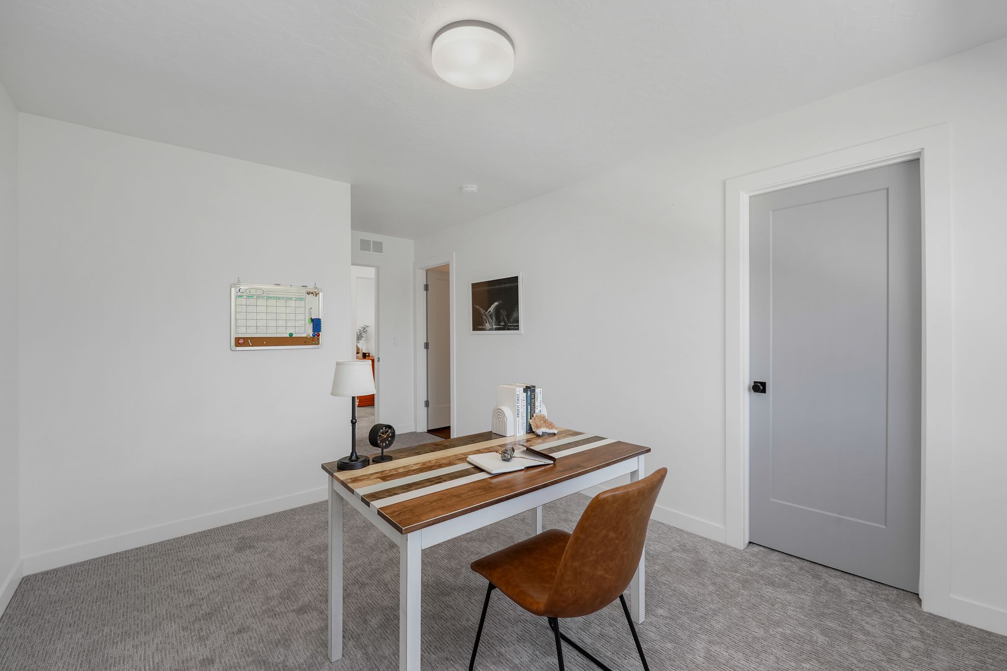 Home office featuring light carpet and baseboards