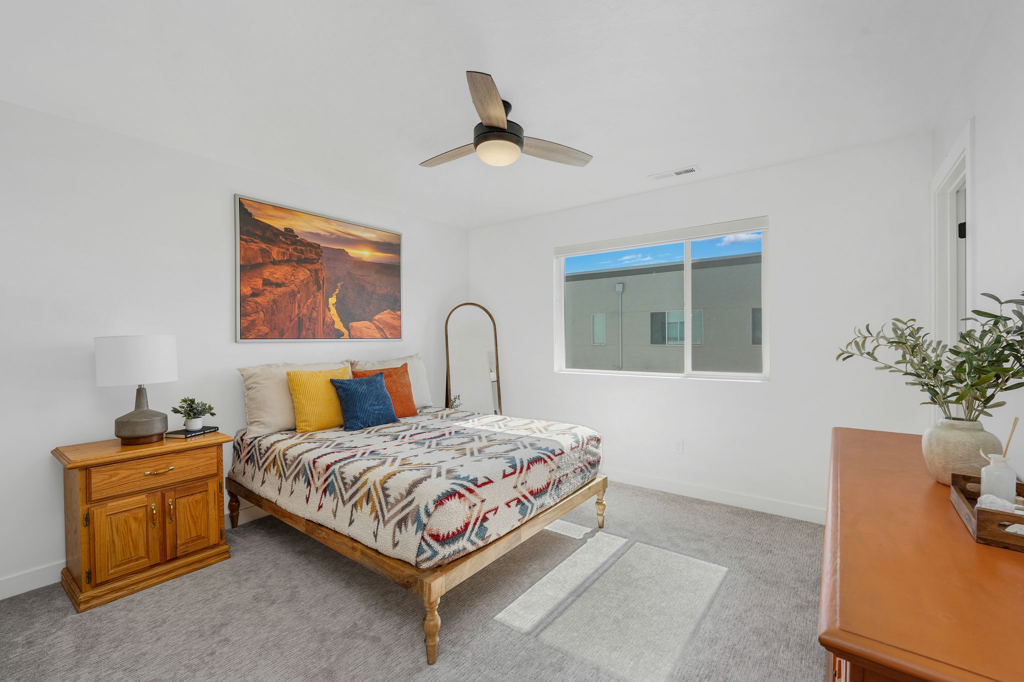 Bedroom with light colored carpet and ceiling fan