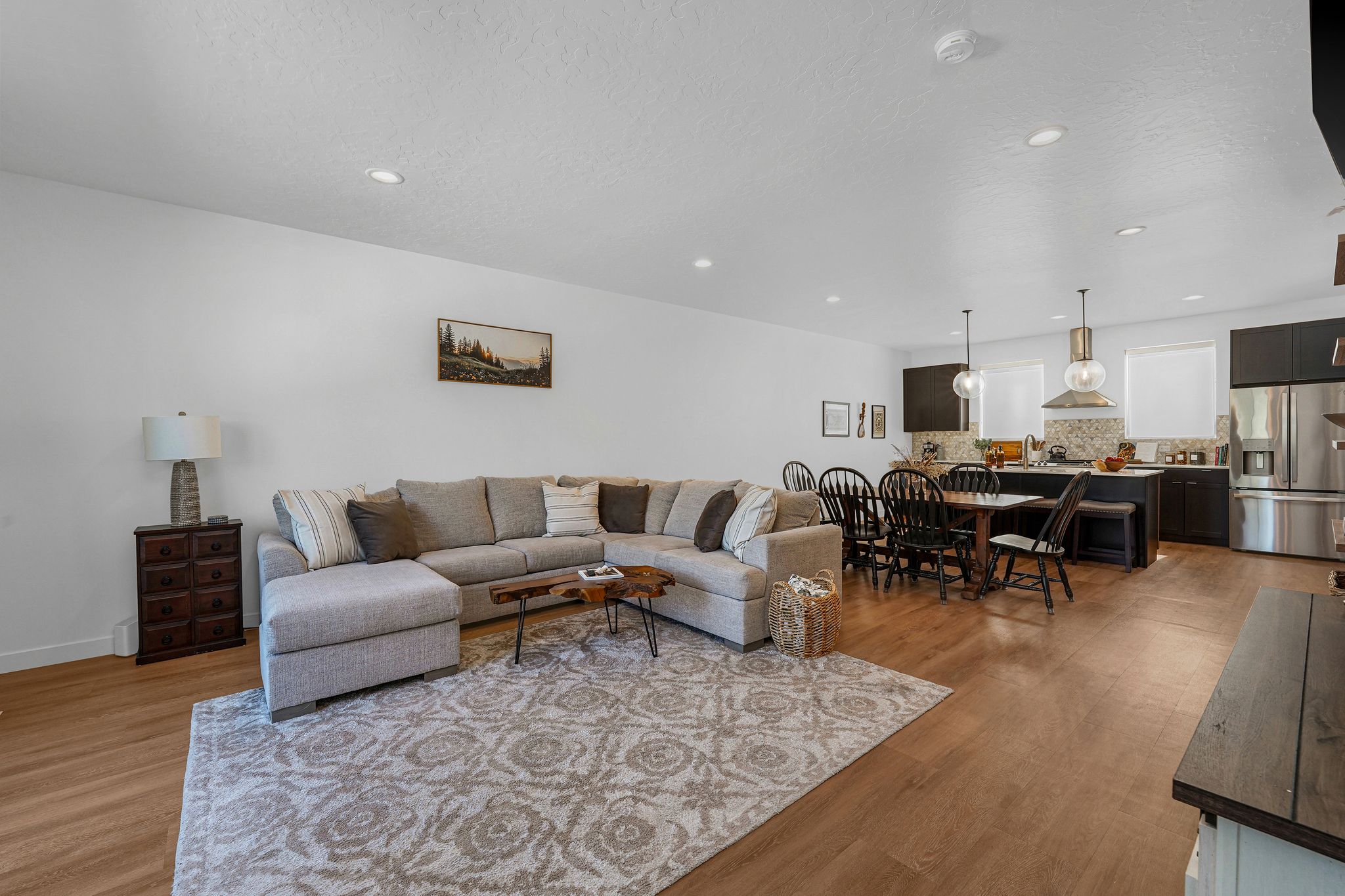 Living area with light wood-style floors, recessed lighting, and a textured ceiling