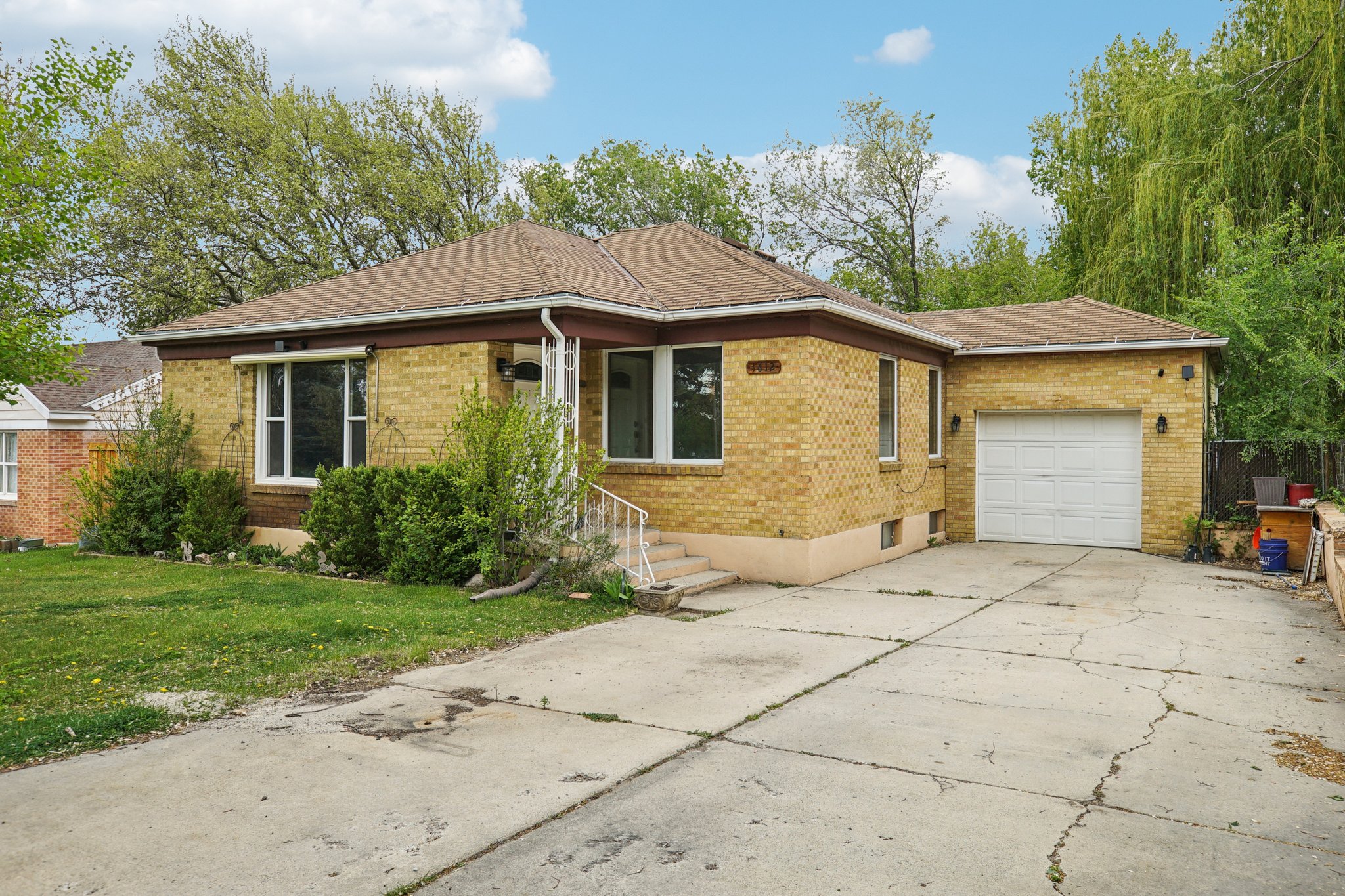 Brick exterior featuring a single-car garage with a white door