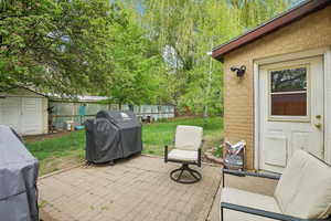View of patio / terrace with a shed and grilling area