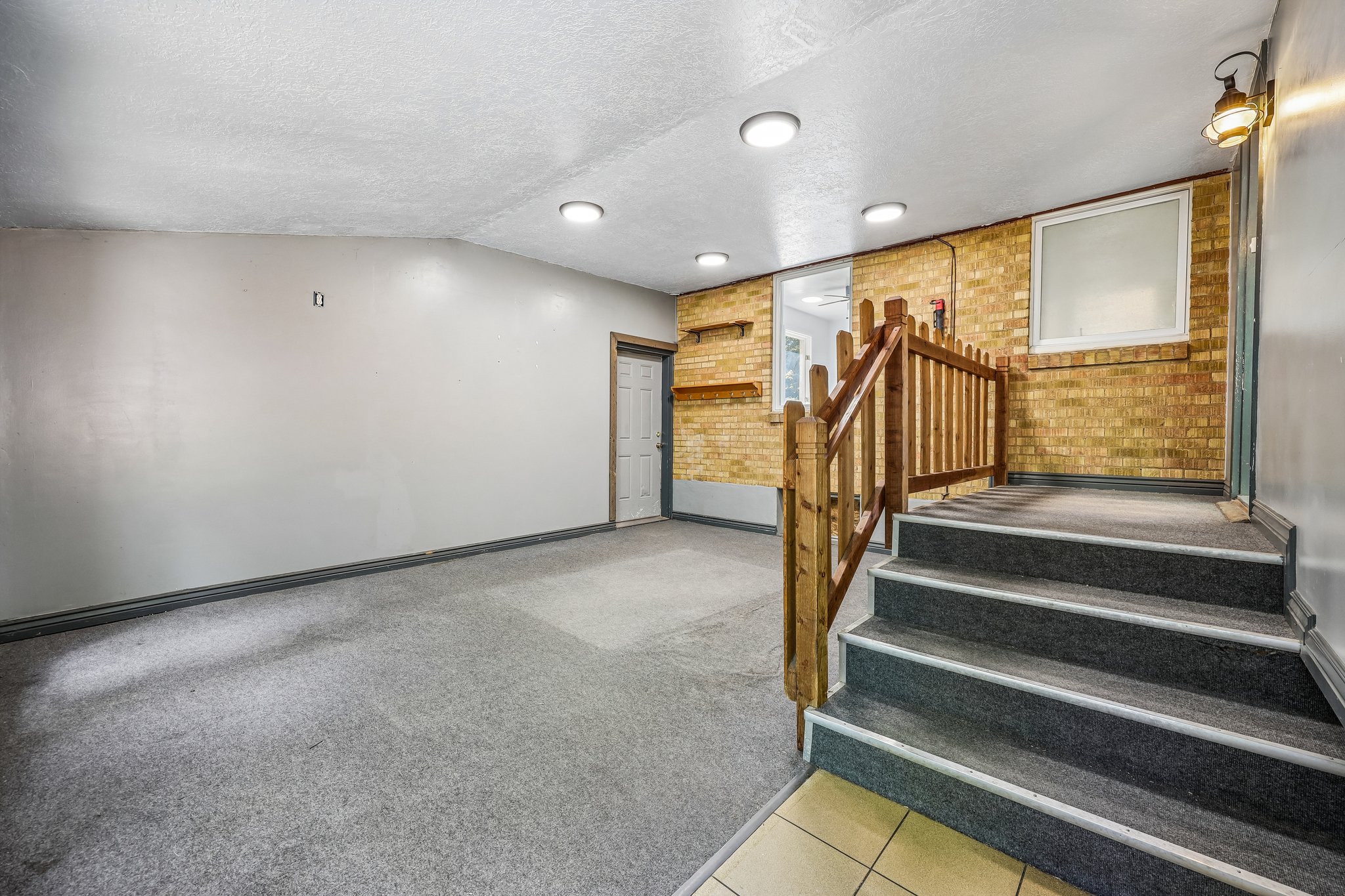 Lower-level area featuring recessed lighting and a carpeted floor