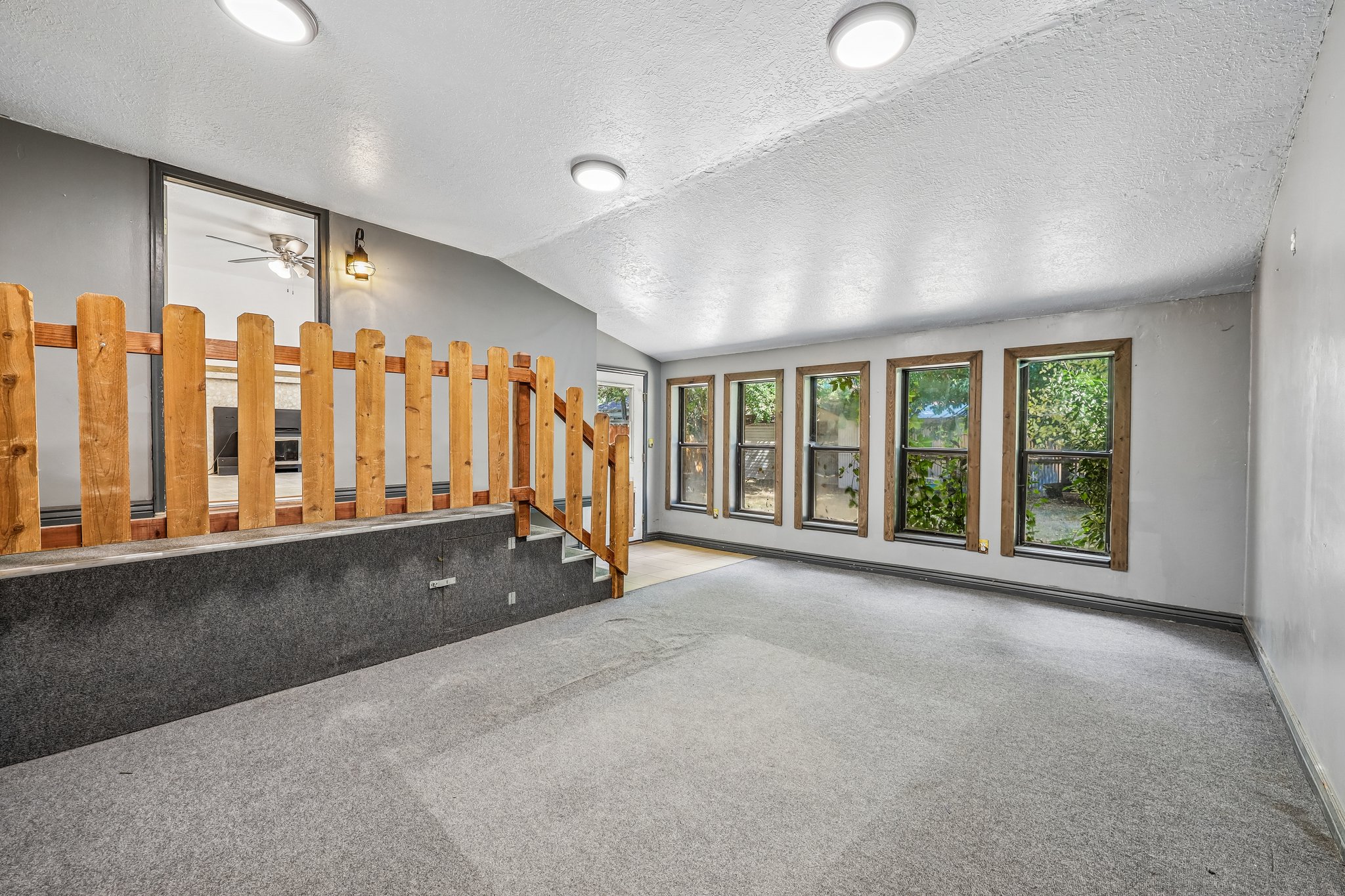 Interior space featuring a split-level design with a natural wood railing
