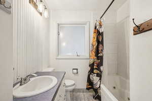 Bathroom with vanity and shower / bathtub combination with curtain
