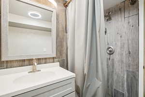 Bathroom featuring a stall shower and vanity