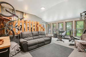 Living room with vaulted ceiling and carpet floors