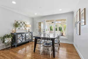Dining room featuring wood finished floors, crown molding, recessed lighting, and ceiling fan