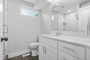 Bathroom featuring vanity and a stall shower