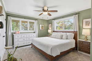 Bedroom featuring light carpet, a ceiling fan, and ornamental molding