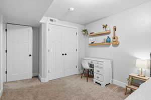 Office space with light colored carpet and a textured ceiling