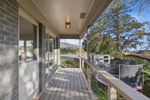 Wooden terrace featuring a mountain view