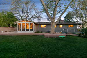 Back of house with a wooden deck and brick siding