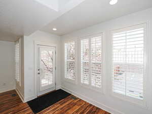 Doorway featuring wood finished floors and recessed lighting