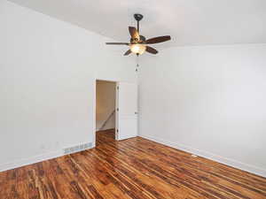 Spare room featuring dark wood-style flooring, a ceiling fan, and a textured ceiling