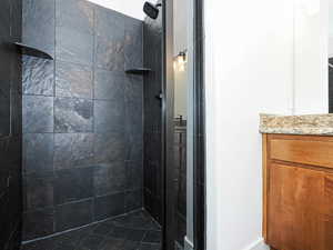 Full bathroom with a shower stall and vanity