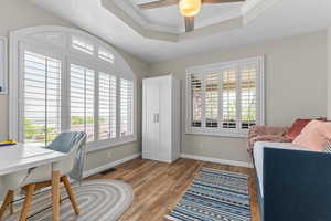 Bedroom with French doors, armoire and large windows.