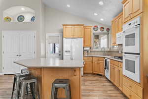 Kitchen with large pantry and entrance to front deck/patio.