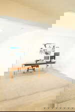 Office space featuring light wood-style flooring and light carpet