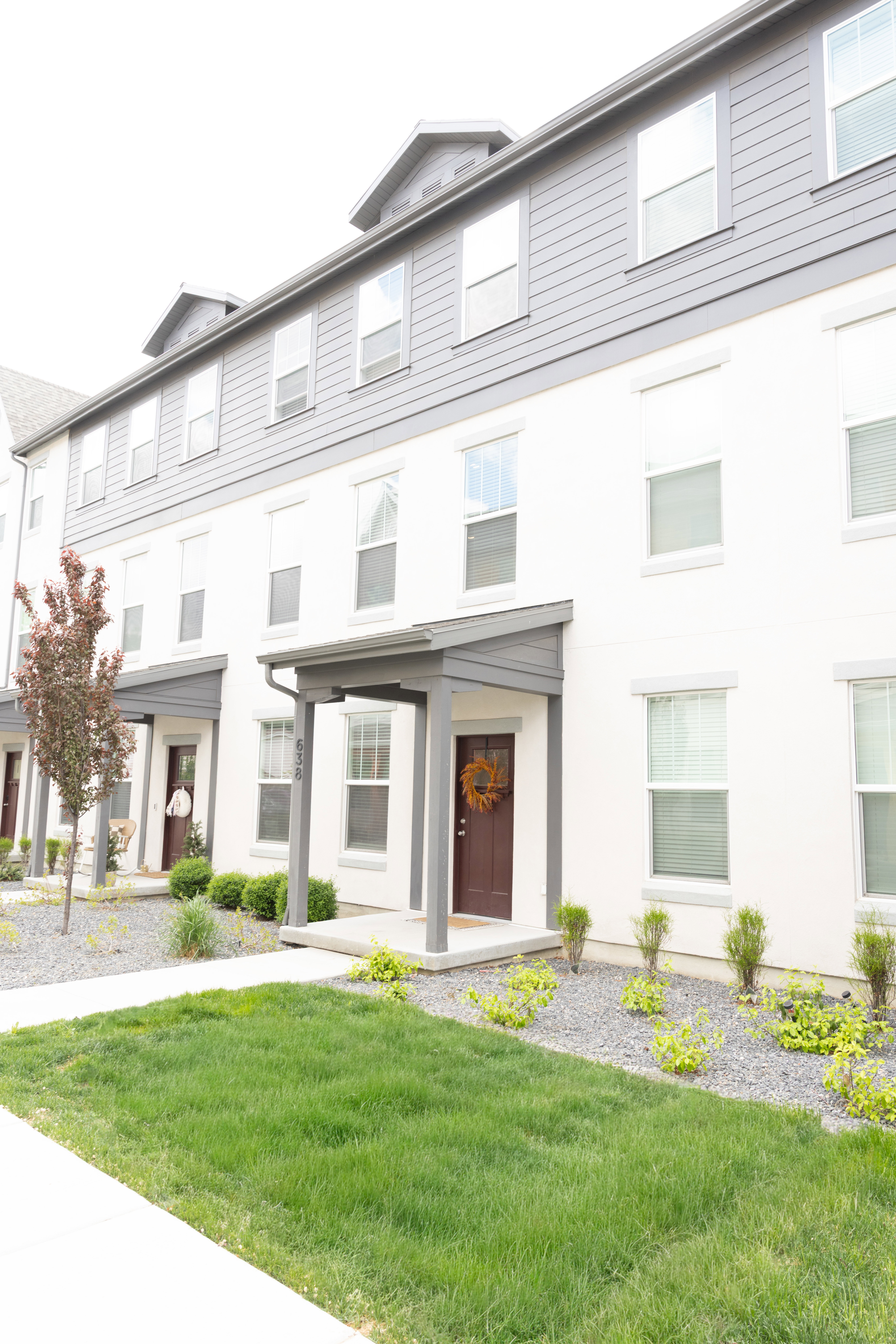 View of front facade with a front yard and stucco siding