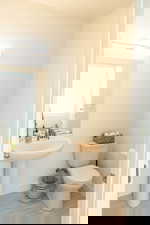 Bathroom with toilet and baseboards