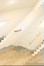 Foyer with light wood-type flooring and baseboards